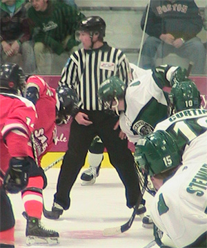 Peter Klim sets the teams for a puck drop in a D3 ECAC matchup between rivals Salem State University and Plymouth State University